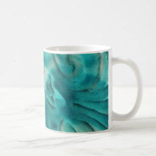 Ein wirbelndes Muster in aquamarin und hellbeige Kaffeetasse