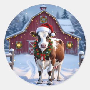 Eine festliche Kuh in der Weihnachtsmannmütze Weih Runder Aufkleber