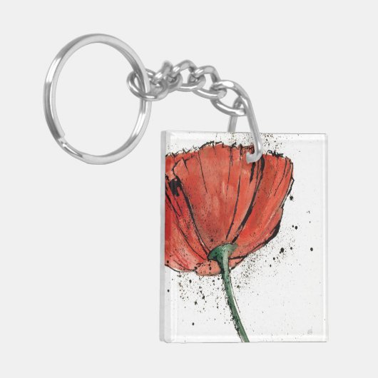 Eine geschlossene Blume auf einem weißen Schlüsselanhänger (Vorderseite links)