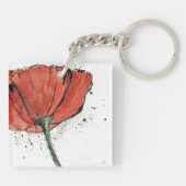 Eine geschlossene Blume auf einem weißen Schlüsselanhänger (Rückseite)