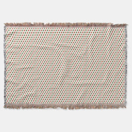 Eine gewebte Decke mit roten und grünen Tupfen 