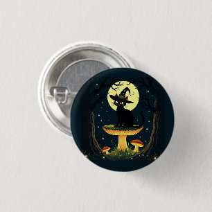 Eine kleine schwarze Hexenkatze sitzt auf einem Gi Button