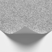 Eine Rolle graues Geschenkpapier mit glitzerndem T (Ecke)