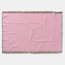 Eine rosa gewebte Decke mit dezenter Musterung 