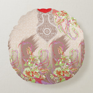 eine rote Vase mit Blume darauf. Rundes Kissen