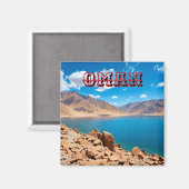 Eine ruhige, türkisfarbene Bucht an der Omani Magnet (Vorderseite/Rückseite)