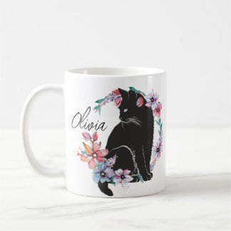 Eine schwarze Katze, umgeben von Blume Kaffeetasse