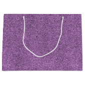 Eine violette Geschenktüte mit Glitter und einem w (Vorderseite)