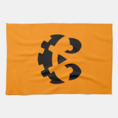 Einfache schwarze Kürbisgesicht an orangefarbenem  Geschirrtuch (Horizontal)