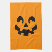 Einfache schwarze Kürbisgesicht an orangefarbenem  Geschirrtuch (Vertikal)