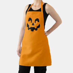 Einfache schwarze Kürbisgesicht an orangefarbenem  Schürze