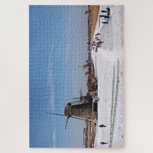 Eis-Skaten entlang den Windmühlen im Winter Puzzle (Vertikal)