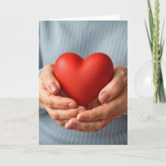 Elderly Woman Holding a Red Heart Karte