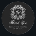 Elegant Black Monogram Wedding Crest Thank You Runder Aufkleber<br><div class="desc">These elegant classic black and white wedding monogram thank you stickers are perfect for favors, place cards, and more. They feature an ornate vintage crest with intertwined fancy script calligraphy monogram, and script Thank You. Find matching products in the collection, or message me through Zazzle Chat for more products and...</div>