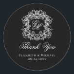 Elegant Black Monogram Wedding Crest Thank You Runder Aufkleber<br><div class="desc">These elegant classic black and white wedding monogram thank you stickers are perfect for favors, place cards, and more. They feature an ornate vintage crest with intertwined fancy script calligraphy monogram, and script Thank You. Find matching products in the collection, or message me through Zazzle Chat for more products and...</div>
