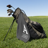 Eleganter Anfangsbuchstabe und graues Golfhandtuch (Gras)