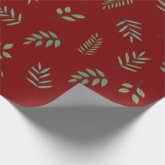 Elegantes grünes Leaf-Wrapping Paper über Deep Red Geschenkpapier (Ecke)