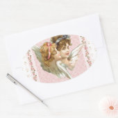 Engel auf rosa geblümtem Hintergrund. Ovaler Aufkleber (Umschlag)