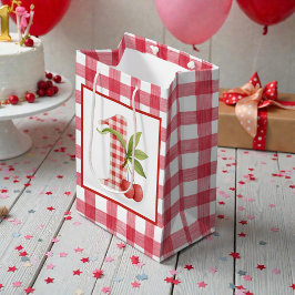 Erstes rotes Gingham-Geburtstagsfest für das Baby Mittlere Geschenktüte