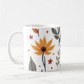 Es ist eine Tasse mit Blume und Blätter. (Links)