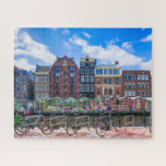 Fahrradhäuser am Canal de Amsterdam Niederlande Puzzle<br><div class="desc">Dieses atemberaubende City-Puzzle bietet Fahrräder entlang des Amsterdamer Kanals mit Gebäude im Hintergrund. #amsterdam #jigsawpuzzle #gift #stockingstuffe</div>