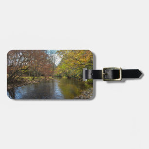 Farbenfrohe Blätter fallen Reflektionen über den H Gepäckanhänger