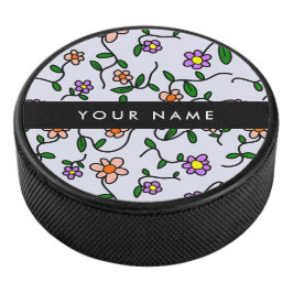Farbenfrohe Blume, blauer Hintergrund, schwarz Eishockey Puck