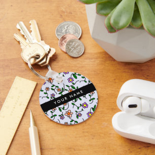 Farbenfrohe Blume, blauer Hintergrund, schwarz Schlüsselanhänger