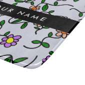 Farbenfrohe Blume, blauer Hintergrund, schwarz Schneidebrett (Ecke)