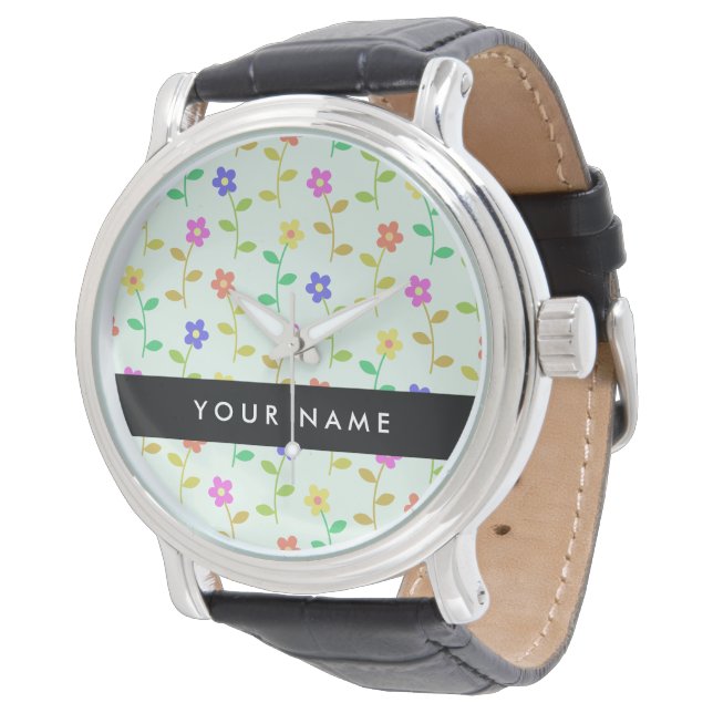 Farbenfrohe Blume, hellgrüner Hintergrund, schwarz Armbanduhr (Schrägansicht)