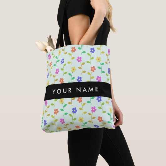 Farbenfrohe Blume, hellgrüner Hintergrund, schwarz Tasche (Von Nahem)