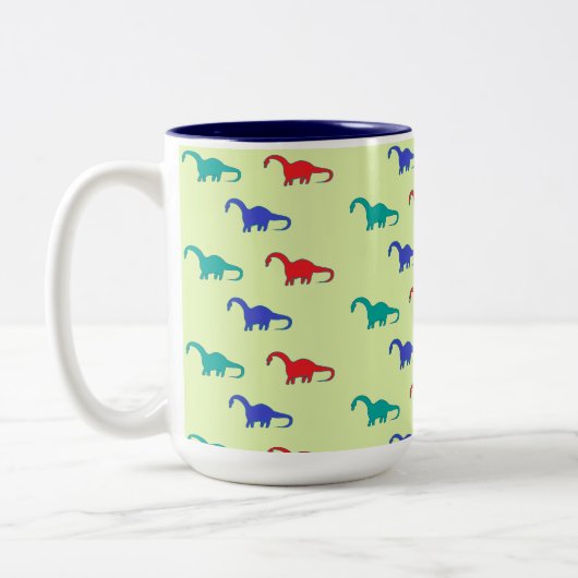 Farbenfrohe Dinosaurier-Muster auf grün Zweifarbige Tasse (Links)