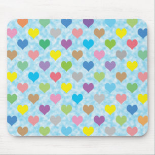 Farbenfrohe Herzmuster auf blauem Hintergrund Mousepad
