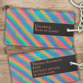 Farbenfrohe Lichtstrahlen fallen in Dunkelheit Schlüsselanhänger