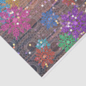 Farbenfrohe schimmernde Schneeflocken auf dem Lacy Seidenpapier (Ausschnitt)