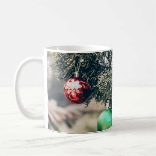 Farbenfrohe Weihnachtsbaumdekoration auf einem Bau Kaffeetasse (Links)
