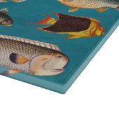 Farbenfroher Fisch unter blauem Meer Schneidebrett (Ecke)