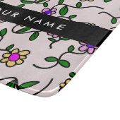 Farbige Blume, rosa Hintergrund, schwarz Schneidebrett (Ecke)