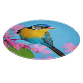 Farbiger Vogel auf blühender Zweigstelle Schneidebrett (Ecke)