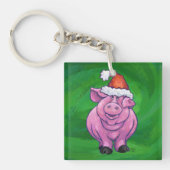 Feierliches Schwein in Weihnachtsmannmütze auf Grü Schlüsselanhänger (Vorderseite)