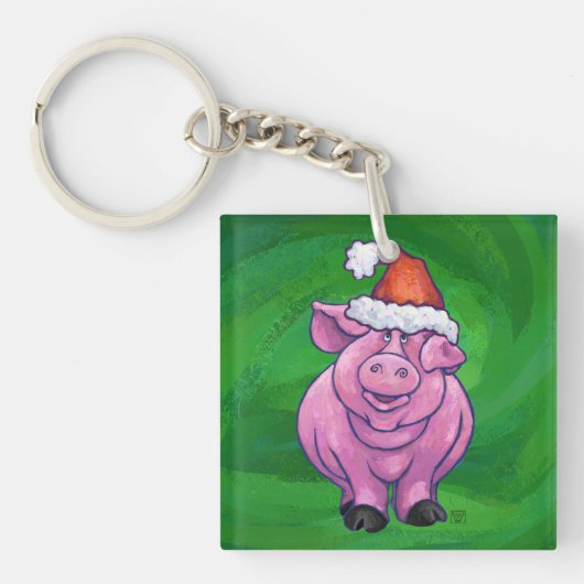 Feierliches Schwein in Weihnachtsmannmütze auf Grü Schlüsselanhänger (Vorderseite)