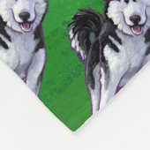 Feiernder Husky in Weihnachtsmannmütze auf Green Fleecedecke (Ecke)