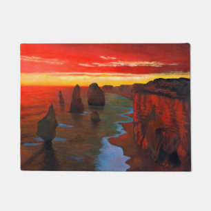 Felsige Küste am Sonnenuntergang Fußmatte