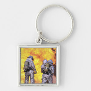 Feuerwehrmänner löschen ein Flugzeugfeuer aus Schlüsselanhänger