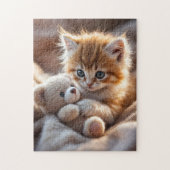 Fluffy red kitten playing with a tiny teddy bear, puzzle (Vertikal)