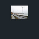 Foggy Morning at Scarborough Leinwanddruck<br><div class="desc">An atmospheric and moody scene of South Bay Beach in Scarborough, North Yorkshire, enveloped in a dense morning fog. Gentle waves lap at the sandy shore in the foreground, creating a foamy edge. The mist partially obscures the vibrant lights of the town and harbor, giving Scarborough a mysterious and ethereal...</div>