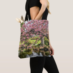 Fotografische Darstellung von rosa Kirschblüten un Tasche