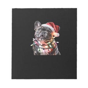 Französische Bulldogge in Santa-Hut eingewickelt i Notizblock