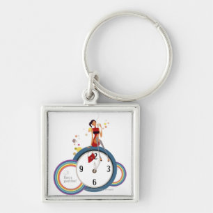 Frau, die auf einer Uhr sitzt und eine Teeschale Schlüsselanhänger