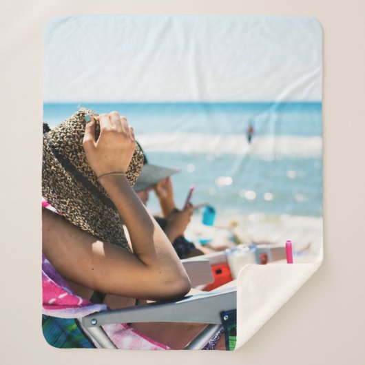 Frauen, die auf einer Sonnenliege liegen und ihr G Sherpadecke (Vorderseite)